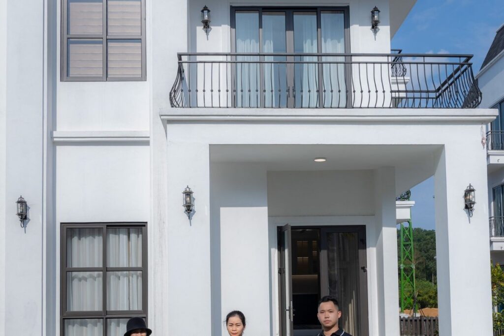 Family in front of their home — refinancing to keep the house after a Wisconsin divorce