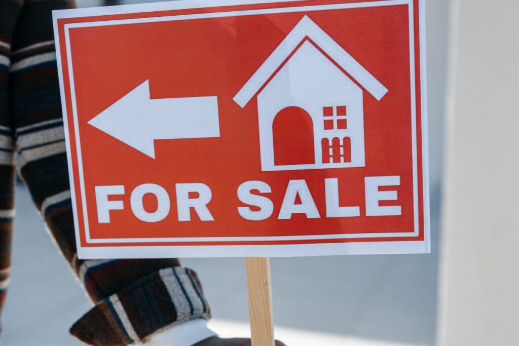 For-sale sign outside a home — deciding whether to keep or sell the house after divorce in Wisconsin